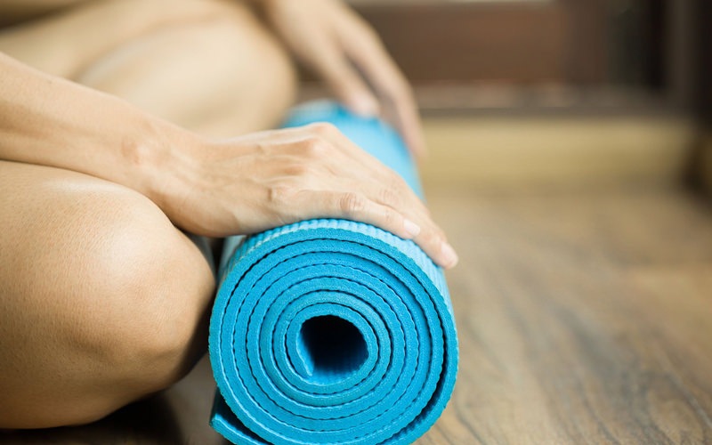 Life style image of a woman on a yoga mat